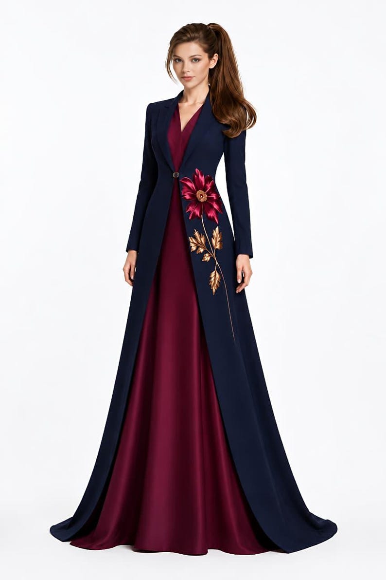 May include: A floor-length gown featuring a deep burgundy sleeveless dress paired with a long-sleeved navy blue coat. The coat has a single button closure at the waist and is decorated with a large embroidered burgundy flower and gold leaves.