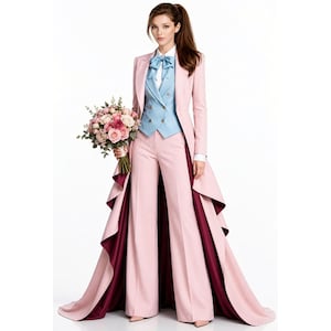 May include: A light pink suit featuring a long-tailed jacket with a deep burgundy lining, wide-leg trousers, and a light blue double-breasted vest with a matching bow tie. The ensemble is paired with a white collared shirt and a floral bouquet.
