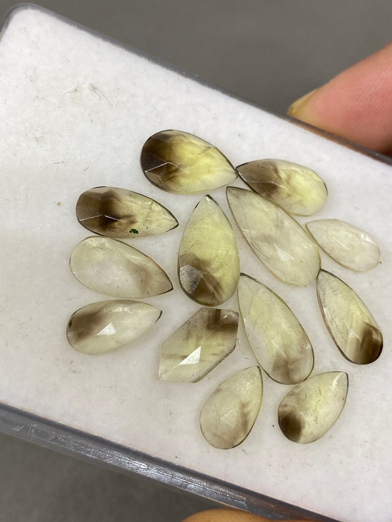 Stunning rare moss green kyanite pear rosecut flats fine quality weight 53 carats size 10.1x5.7mm-18.3x7.4mm pcs 17 moss green rosecut Stunning rare moss green kyanite pear rosecut flats fine quality weight 53 carats size 10.1x5.7mm-18.3x7.4mm pcs 17 moss green rosecut