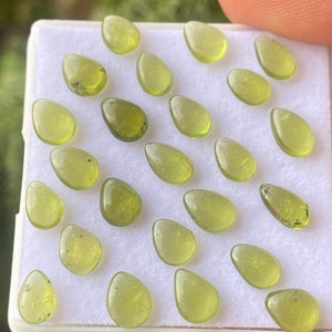 Dazzling fine quality peridot cabochons ovals wholesale lot weight 12.30 carats size 7x5mm pieces 24 peridot cabochons