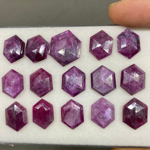 May include: Twelve faceted purple gemstones in a hexagonal shape, displayed in a white box.