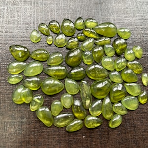 Beautiful fine quality peridot cabochons pear shape wholesale lot weight 65 carats size 5.5x3.5mm-13x8mm pieces 59 peridot cabochons