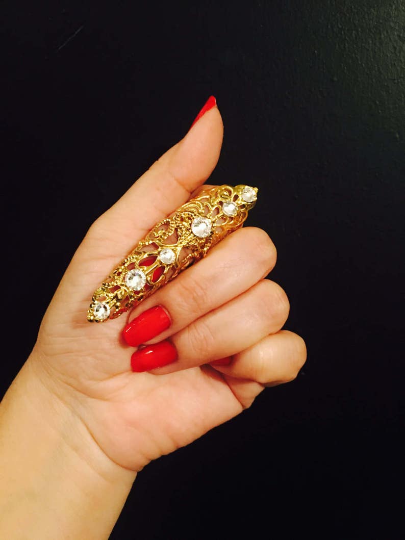 Only made in gold color with clear crystals nail guard,finger tip Double arrow claw ring sizable. 1 pc