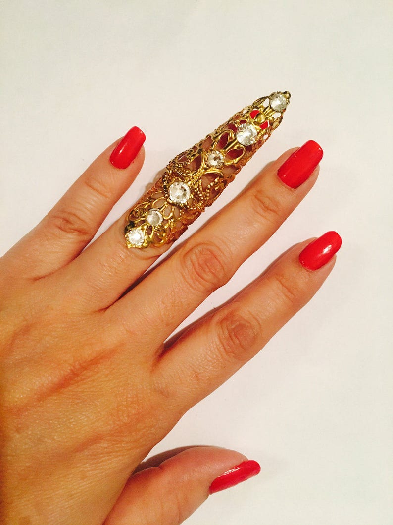Only made in gold color with clear crystals nail guard,finger tip Double arrow claw ring sizable. 1 pc