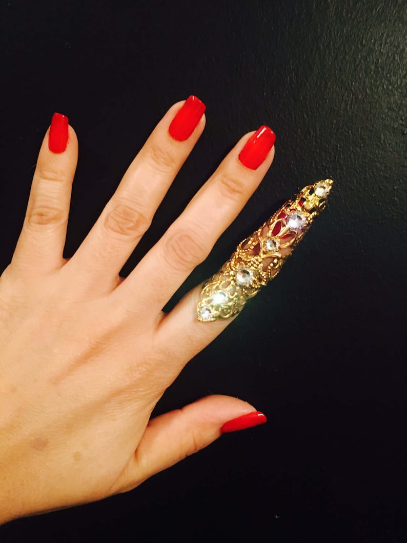 Only made in gold color with clear crystals nail guard,finger tip Double arrow claw ring sizable. 1 pc