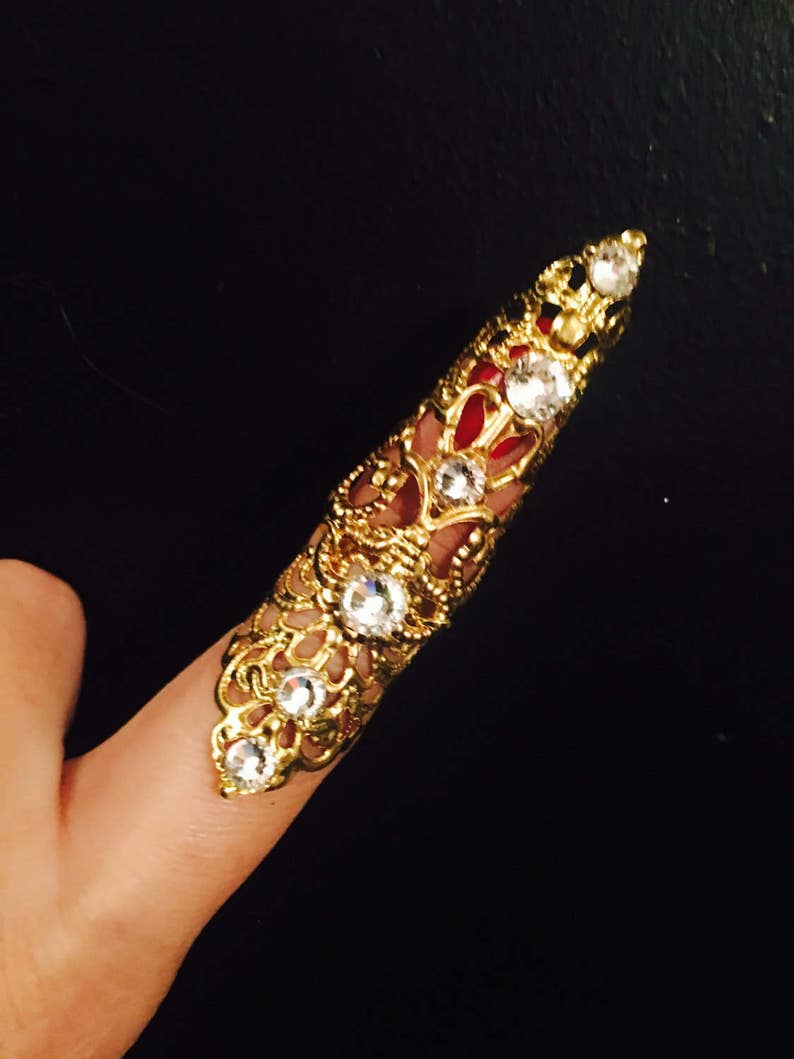 Only made in gold color with clear crystals nail guard,finger tip Double arrow claw ring sizable. 1 pc