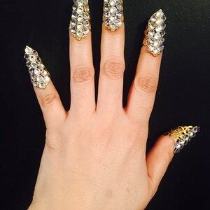 Short crystal nail guards,claw rings or finger tips,made in gold color filigree with clear crystals, set of 5pcs. They are  sizable.