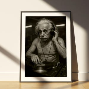 May include: Black and white framed print featuring a man with white hair and a mustache wearing headphones and a tank top, operating a record player. The image is a sepia-toned photograph.