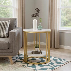 May include: A round side table with a white marble top and a gold metal frame. The table has a lower shelf and is decorated with a white vase, a small green glass bottle, and a potted plant. The table is next to a gray sofa.