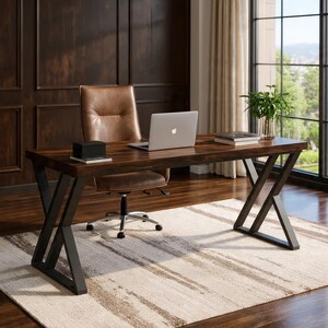 May include: A dark brown wooden desk with black metal legs, a brown leather office chair, and a laptop. A small black box and a book sit on the desk. The desk is on a patterned rug in a well-lit room.