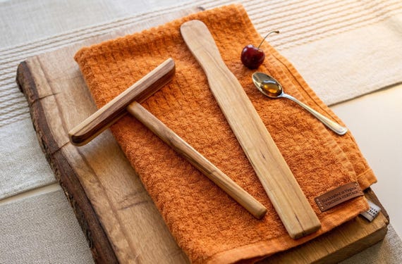 A dedicated wild cherry wood crepe-making tool set (spreader + turner) is a hyper-specific, beautifully crafted gift that crepe lovers didn't know they needed.