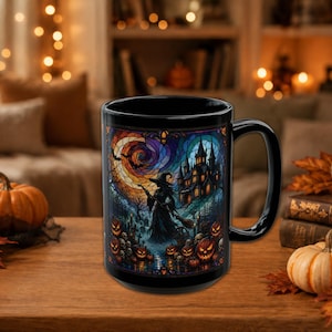 May include: A black ceramic mug featuring a colorful stained-glass style illustration of a witch standing before a dark castle, a swirling moon, and bats, surrounded by glowing jack-o'-lanterns and skulls in a detailed, dark fantasy scene.