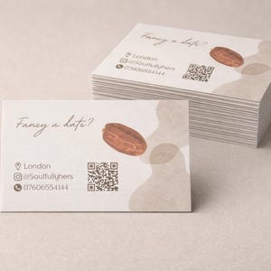 May include: A pile of business cards with a simple design. Each card displays the text "Fancy a date?" and a watercolour illustration of a date. Contact details and a QR code are also included.