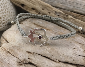 Artisan Om bracelet made of silver with a natural stone, ruby,  and adjustable clasp in macramé. Boho chic style.