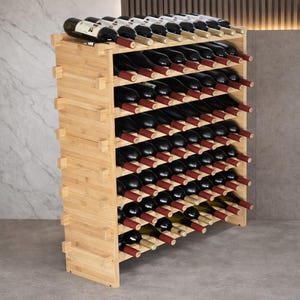 May include: A wooden wine rack filled with numerous wine bottles. The rack is made of light-colored wood and has multiple shelves designed to hold the bottles at an angle. The bottles are mostly dark, with red and white labels visible.