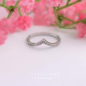 May include: A set of three ceramic mugs with a speckled, matte finish. The mugs are in shades of cream, light gray, and dark gray. Each mug has a simple, minimalist design, perfect for coffee or tea.