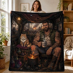 May include: A rectangular fleece blanket featuring a detailed illustration of a bearded, tattooed person sitting inside a vehicle with a fluffy orange cat, a small fire, and a mug labeled CUSTOM NAME, set against a backdrop of a burning city.
