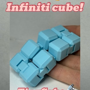 May include: A white ceramic mug with a black handle and the text "But First, Coffee" in a bold, black font. The mug is set against a blurred background, suggesting a cozy setting.