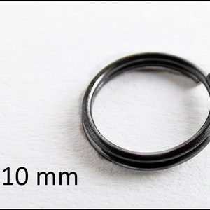 May include: A silver-colored metal key ring with a diameter of 10 mm. The ring is double-looped and appears to be made of sturdy metal.