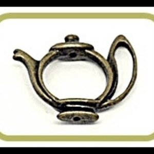 May include: Antique gold-tone teapot charm with a detailed design. The charm has a spout, handle, and lid. It is a small, delicate charm that would be perfect for jewelry making or scrapbooking.