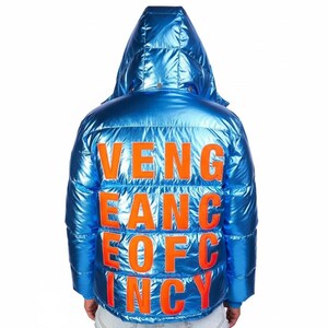 May include: A shiny, blue puffer jacket with a hood. The back of the jacket features the orange text "VENGEANCE OF INCY". The jacket has a metallic sheen and a quilted design.