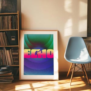 May include: A framed art print displaying the word "ECHO" in a gradient of yellow, pink, and purple. The background features concentric circles in shades of green, blue, and purple. The print is leaning against a wall next to a blue chair.