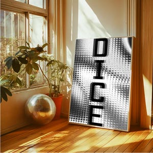 May include: A framed art print displaying the word "DICE" in black, bold letters. The background features a textured, silver and grey pattern. A disco ball and potted plants are near a window, with sunlight on the wooden floor.