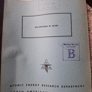 May include: A pale blue document with the title "Self-Diffusion in Silver" from the Atomic Energy Research Department, North American Aviation, Inc. The document has a stamp that reads "Received Apr 7 1952". The cover also has the text "NAA-SR-170" and "Metallurgy and Ceramics".