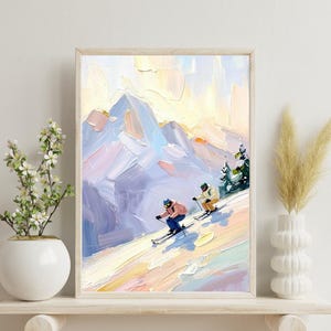 May include: Oil painting print of a mountain ski scene. The artwork features skiers descending a snowy slope, with a backdrop of snow-covered mountains and a pastel sky. The painting is framed in a light wood frame.