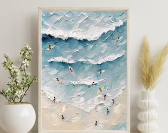 May include: Framed art print depicting a beach scene with surfers and swimmers in the ocean. The artwork features textured brushstrokes in shades of blue and white, with a light wooden frame. The overall theme is coastal and summery.
