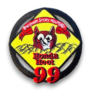 May include: Embroidered patch featuring a cartoon owl with the text "Honda Hoot 99" and "The Great Smoky Mountain." The patch has a yellow diamond shape with a black border and red accents.