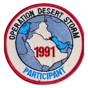 May include: Circular patch with a red border and the words "OPERATION DESERT STORM" and "PARTICIPANT." The patch features a globe with blue and red accents and the year "1991" in red and gold.