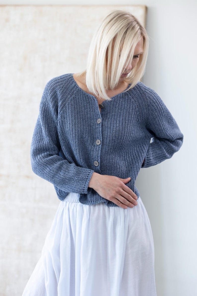 Woman wearing blue knit cardigan, soft relaxed silhouette
