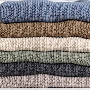 Stack of knitted sweaters, cotton and wool blend color options
