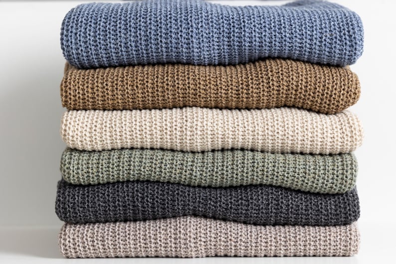 Stack of knitted sweaters, cotton and wool blend color options