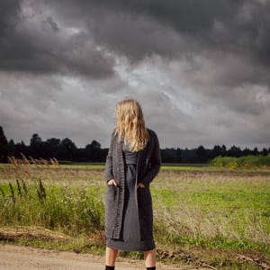 Luxury handmade Donegal wool cardigan in natural outdoor landscape, heritage winter knitwear