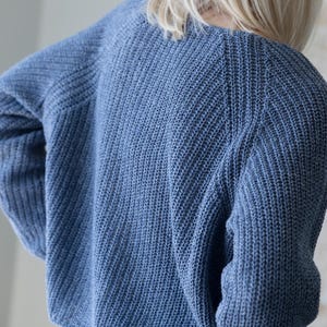 Back view blue knit cardigan, relaxed oversized fit sweater