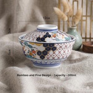 May include: A ceramic bowl with a lid, featuring a bamboo and pine design. The bowl is white with blue, yellow, and red floral and geometric patterns. It measures 12cm in diameter, 6cm high, and the lid is 3cm high. Capacity is approximately 300ml.
