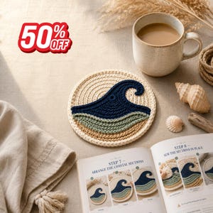 May include: A round crochet coaster featuring a layered wave design in navy blue, sage green, and tan on a cream background. An open instructional book displays steps for assembly, alongside a ceramic mug and seashells on a neutral fabric.