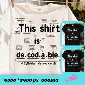 May include: A cream-colored short-sleeve t-shirt featuring black text and linguistic diagrams. The graphic displays the phrase 'This shirt is de.cod.a.ble.' with arrows pointing to grammatical labels like 'Digraph', 'Prefix', and '4 Syllables'.