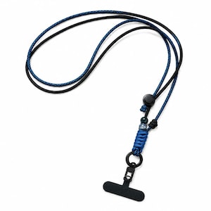 May include: A lanyard featuring a dual-cord design with one solid black cord and one textured blue cord. The assembly includes a black plastic slider, two small decorative beads, a blue braided cord section, a black metal ring, and a black clip.