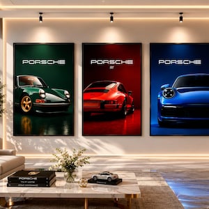 May include: Three vertical wall art prints featuring Porsche sports cars. The left print shows a green car, the centre print displays a red car with the text Porsche 911, and the right print depicts a blue car. Each print includes the Porsche logo.