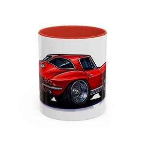 May include: A white ceramic mug with a red interior features a cartoon illustration of a red classic car. The car has large chrome wheels and is set against a white background. The mug is suitable for hot or cold drinks.
