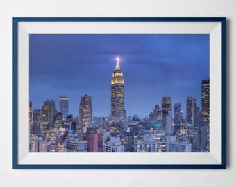 NYC, The Empire State Building - Photographic print of a view of New York City with a skyscraper in the centre of it after sunset.