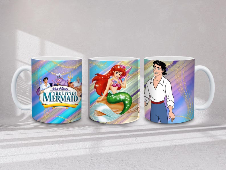 May include: Three white ceramic mugs featuring characters from Disney's "The Little Mermaid." One mug displays the movie title and characters, another features Ariel, and the third shows Prince Eric. Each mug has a colorful, iridescent background.
