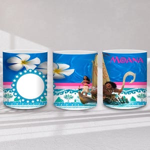 May include: White ceramic mug featuring designs from the animated film Moana. The mug has a blue background with images of the characters, the word "Moana", and tropical flowers. The mug has a white handle.