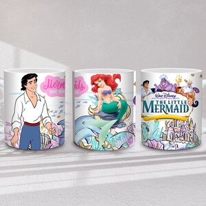 May include: Three white ceramic mugs featuring characters and scenes from Disney's "The Little Mermaid." One mug depicts Prince Eric, another Ariel, and the third showcases the movie's title and characters. The mugs have a curved handle.