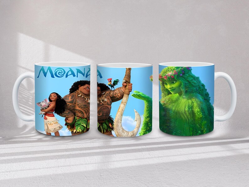 May include: Three white ceramic mugs featuring characters from the animated film "Moana." The mugs display images of Moana, Maui, and Te Fiti against a blue sky background. The word "MOANA" is printed in blue on one of the mugs.