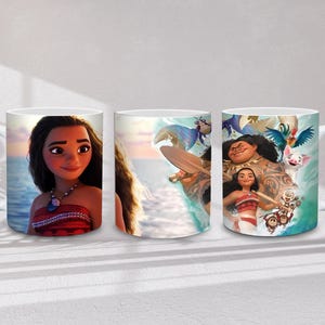 May include: Three white ceramic mugs featuring characters from the animated film Moana. The mugs display images of Moana, Maui, Pua, Hei Hei, and other characters. The mugs have white handles and a glossy finish.
