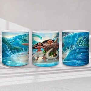 May include: White ceramic mug with a colourful illustration of characters from the animated film Moana. The design features Moana, Maui, and ocean waves in blue and turquoise hues. The mug has a white handle and a glossy finish.
